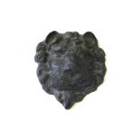 A lead 'lion mask' wall plaque, early 19th century, 25cm high.