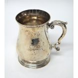 A George II silver mug of baluster form, the plain body with scroll handle, initial engraved,