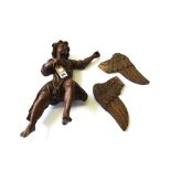 A late 17th century carved wood figure depicting a winged angel in flight, his arm outstretched,