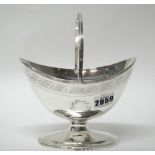 A George III silver sugar basket, of oval form with bright cut engraved decoration,