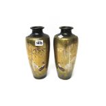 A pair of Japanese bronze vases, Meiji period, of slender tapered form, each inlaid in copper,