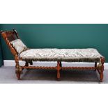 A William and Mary carved walnut framed cane upholstered day bed on barley-twist supports,