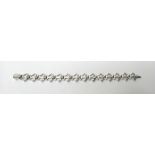 A Garrard fleur de lys 18ct white gold and diamond set bracelet,