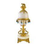 An early 20th century gilt metal and opaque glass mounted scent bottle stand of egg form,