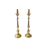 A pair of Victorian brass altar candlesticks, each of turned form,