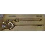 A set of Victorian brass fire irons, with square trellis work handles, the shovel 68.5cm (3).