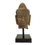 An Indonesian stone head of Buddha Shakyamuni, possibly 9th century,