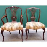 A matched set of twelve mahogany framed dining chairs with pierced splat and serpentine seat on