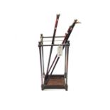 A Victorian tubular brass and cast iron four division stick stand of rectangular form, 62cm high,