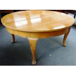 A 19th century French satin birch circular extending dining table on four cabriole supports,