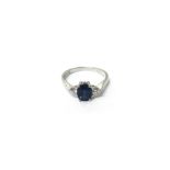 An 18ct white gold, sapphire and diamond set three stone ring,