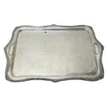 A late Victorian large silver twin handled tray of shaped rectangular form,