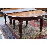 A Victorian mahogany circular extending dining table on eight tapering reeded supports,