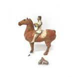A Han style grey pottery equestrian figure, picked out in white, red and black pigments, (a.