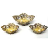 A Victorian silver gilt bonbon basket of shaped oval form, together with two smaller baskets,