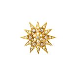 A gold, diamond and seed pearl set pendant brooch, designed as a starburst,