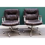 A pair of mid 20th century polished steel and rouge leather office swivel chairs,