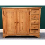 A 19th century pine side cabinet, with pair of panel doors enclosing shelves,