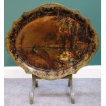 A Victorian papier mache tray painted with peacocks in a landscape,