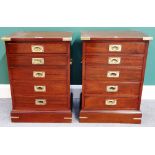 A pair of campaign style brass bound mahogany bedside chests of five long graduated drawers,