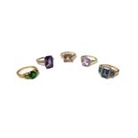 A 9ct gold ring, claw set with a cushion shaped amethyst between diamond set four stone shoulders,