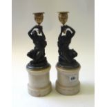 A pair of French gilt and patinated bronze figural candlesticks of Louis XVI style,