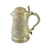 A George II silver hinge lidded tankard, of baluster form, later decorated with hunting scenes,