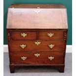 A small 18th century oak bureau, the fitted interior over two short and two long drawers,