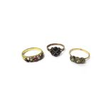 A Victorian gold, garnet and seed pearl set cluster ring and two further gem set rings.