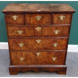 A William and Mary featherbanded walnut chest of three short and three long graduated drawers,