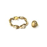 A gold and cultured pearl bracelet, the shaped oval twin section links, centred by cultured pearls,