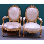 A pair of Louis XV style gilt framed fauteuils, with serpentine seat on cabriole supports.