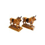 Two Mafra pottery bulls, circa 1900, each canister decorated in mottled browns,