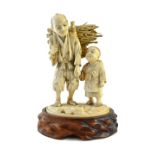 A Japanese ivory okimono of a man and child, Meiji period, standing holding hands,