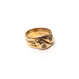 An 18ct gold and diamond set ring, designed as two entwined snakes,