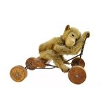 A Steiff peddling monkey, pre-war, with golden fur and jointed limbs,