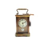 An Edwardian gilt brass cased carriage clock, with enamel dial and subsidiary alarm dial,