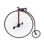 A reproduction of a Victorian penny farthing, painted burgundy,