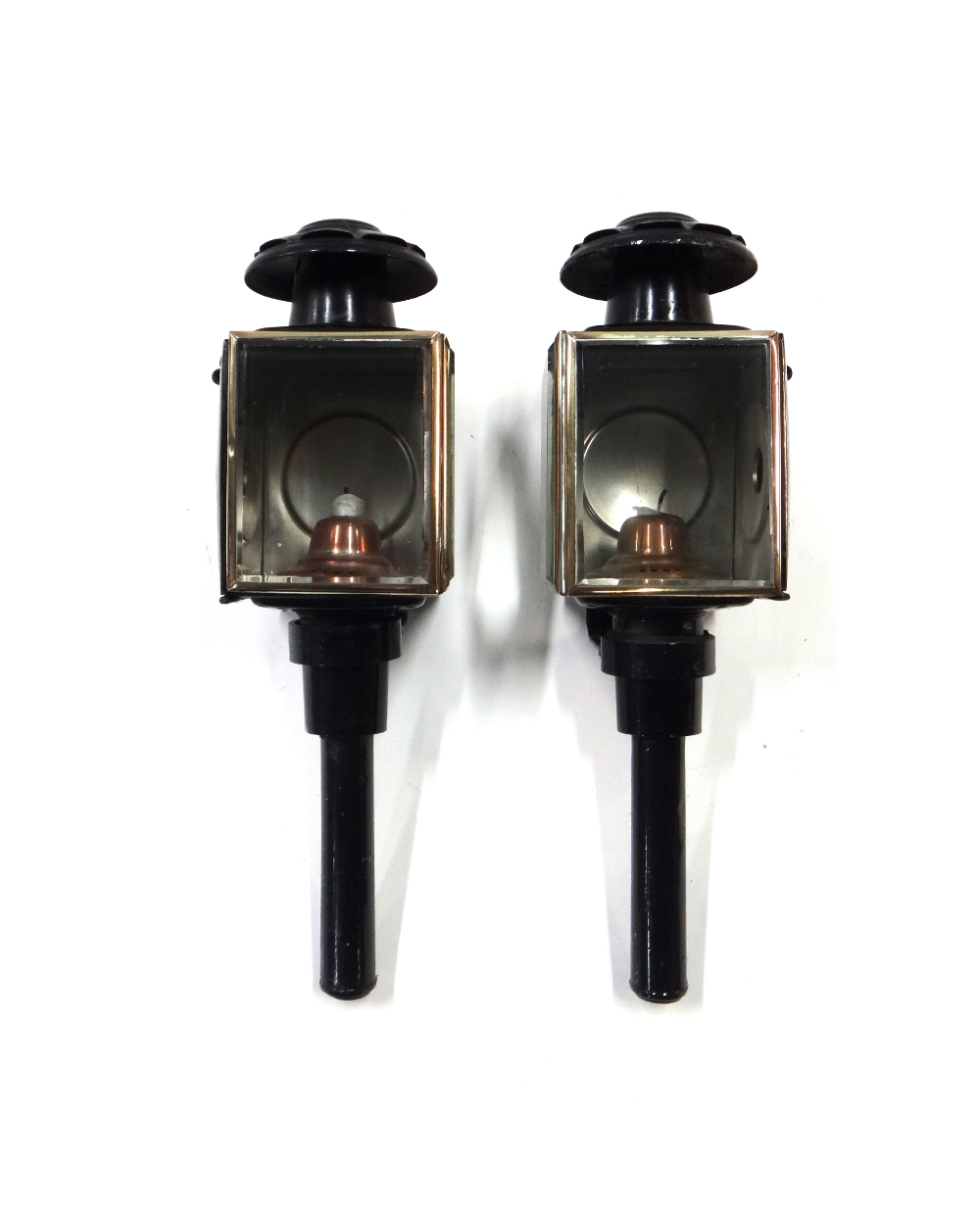 A pair of black painted metal coach lamps.