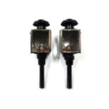 A pair of black painted metal coach lamps.