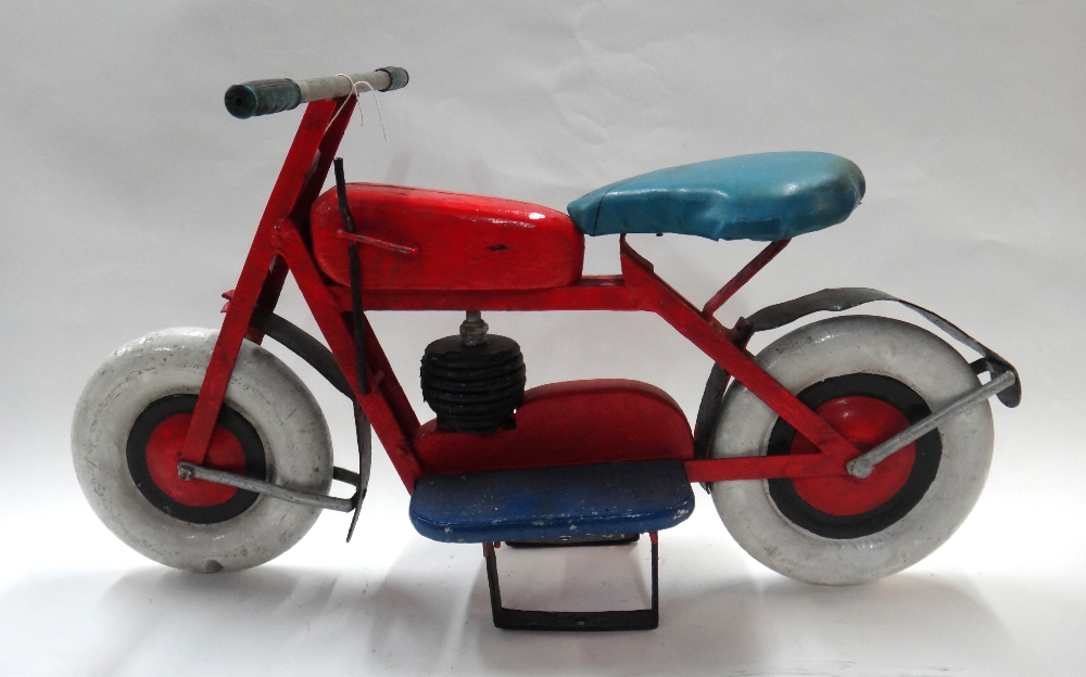 An early 20th century child's wooden motorcycle, previously from a fairground ride.