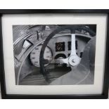 A framed black and white photograph of a pre-war Auto Union cockpit,