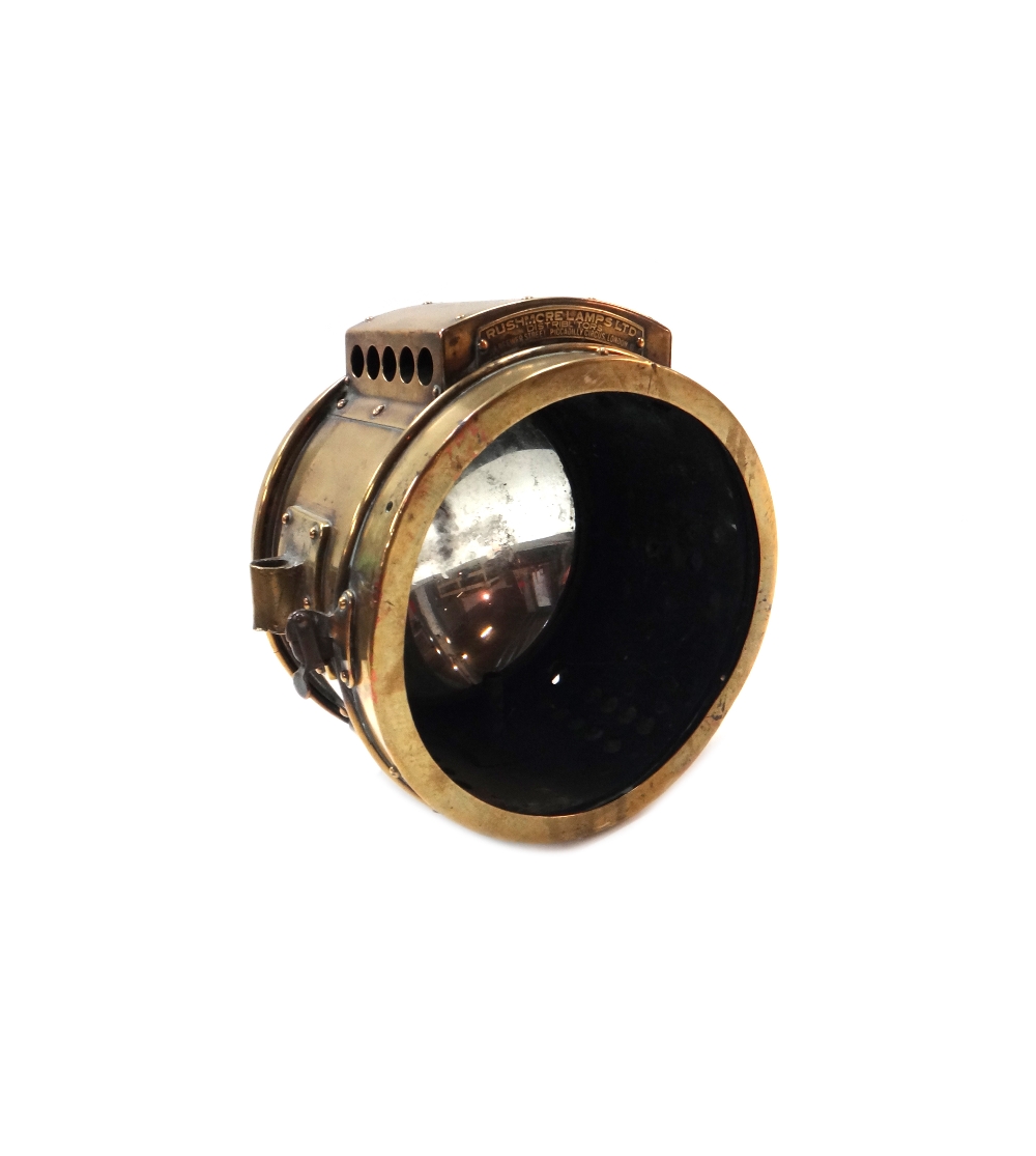 An eight inch brass cased 'Rushmore' automobile searchlight, lacking front glass.