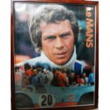 A 1970's framed photographic print of Steve McQueen at Le Mans, 42cm wide x 55cm high.