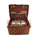 A mid 20th century automobile picnic set, contained in a wicker basket, 56cm wide x 41cm deep.