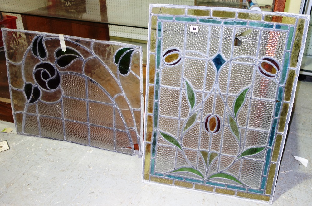 Two similar stained leaded glass windows, each 23 x 31cm.