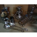 A box of electro-plated wares including candlesticks, flatware, bowls, a tea set and sundry.