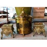 A brass coal bin and a pair of fireside stands.