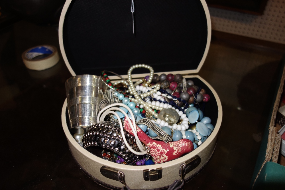 A quantity of costume jewellery and a silver plated beaker.