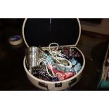 A quantity of costume jewellery and a silver plated beaker.